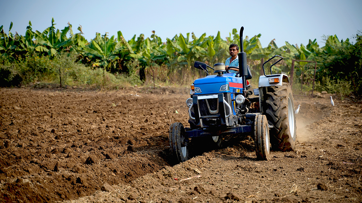 TREM Stage-IV: How India’s New Emission Standards are Impacting the Off-highway space Indian farmer working with tractor in agriculture field.