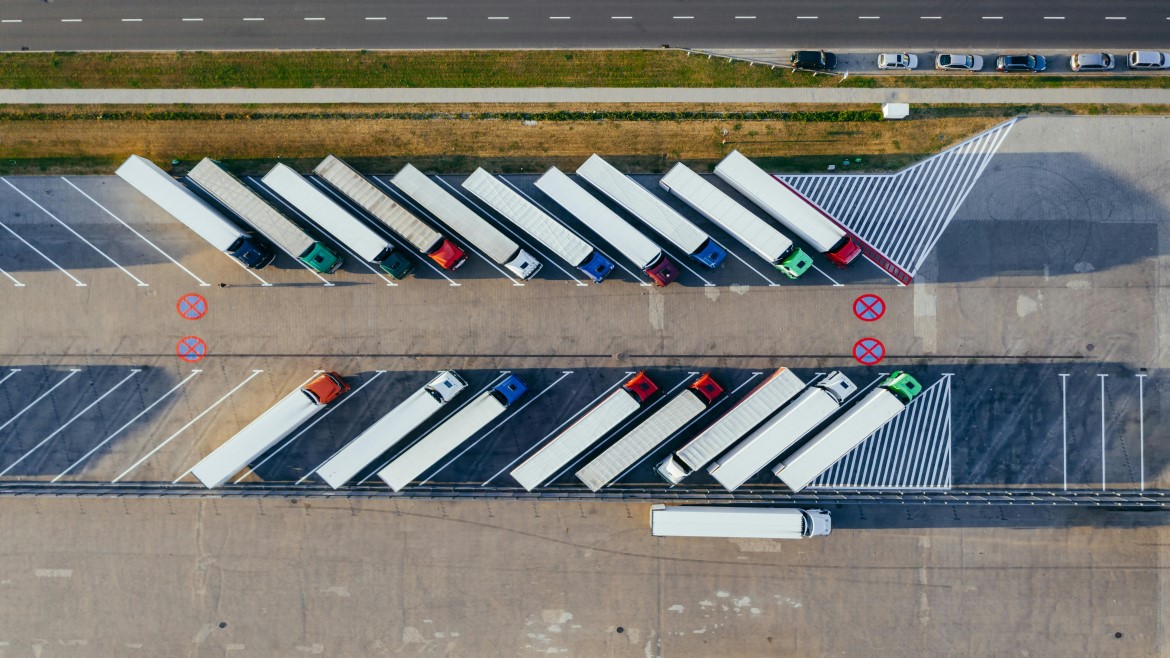 Aerial view of heavy duty trucks parked in a chevron pattern